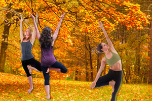 Ayurveda Vata Season Women doing Tree Yoga Pose among fall trees | My Yoga Essentials